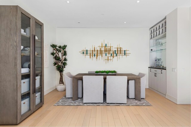 bar with light wood-style floors and baseboards