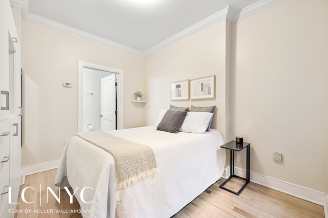 bedroom featuring crown molding, baseboards, and wood finished floors