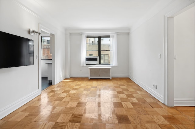 unfurnished living room with radiator heating unit and baseboards