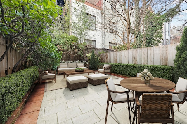 view of patio with outdoor dining area, outdoor lounge area, and a fenced backyard