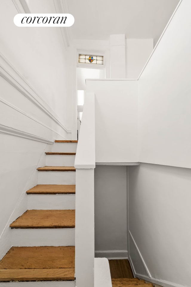 stairway with wood finished floors