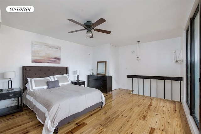 bedroom with light wood finished floors, ceiling fan, and visible vents