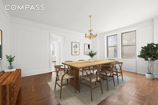 dining space featuring a decorative wall and a notable chandelier