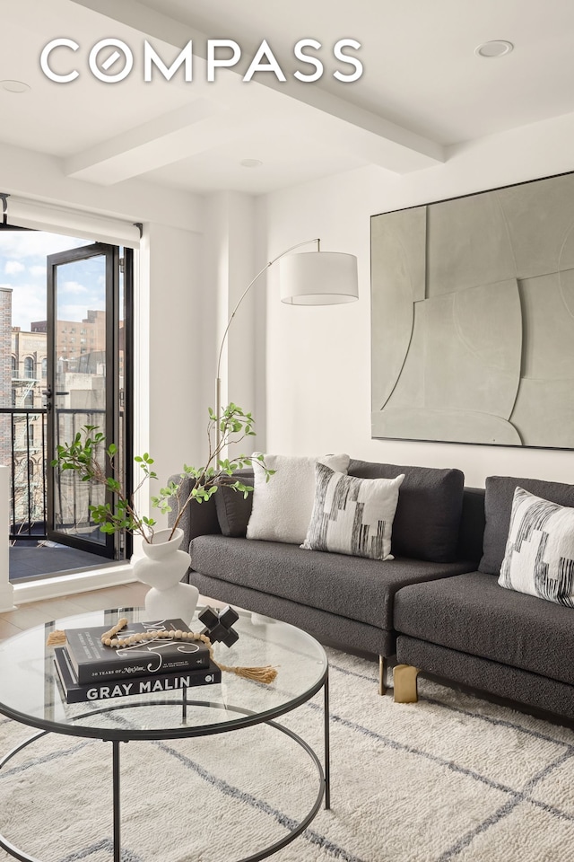 living area with recessed lighting, beamed ceiling, and a view of city