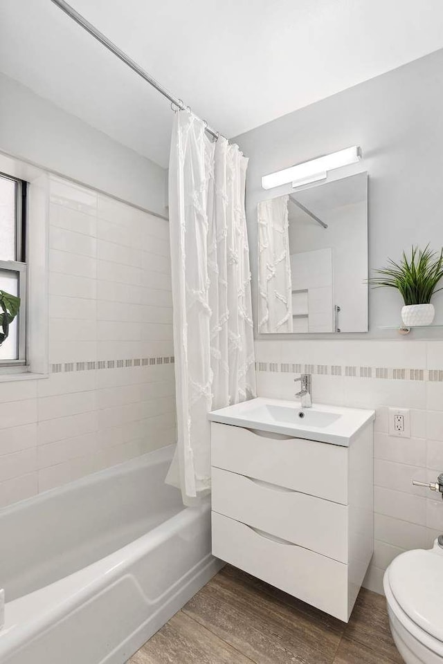 175 W 13th St Unit 3G, New York City, NY 10011 - full bathroom featuring vanity, toilet, wood finished floors, and shower / bath combination with curtain