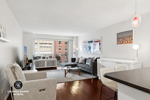132 E 35th St Unit 11F, New York City, NY 10016 - living area featuring hardwood / wood-style flooring and a textured ceiling