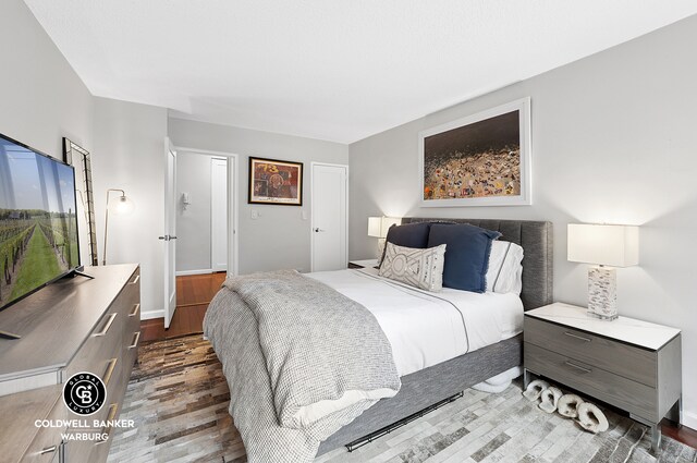 132 E 35th St Unit 11F, New York City, NY 10016 - bedroom featuring wood finished floors and baseboards