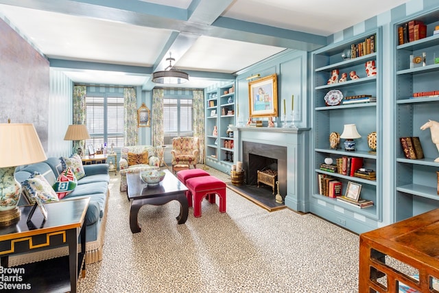 sitting room featuring built in features, coffered ceiling, beam ceiling, and a high end fireplace