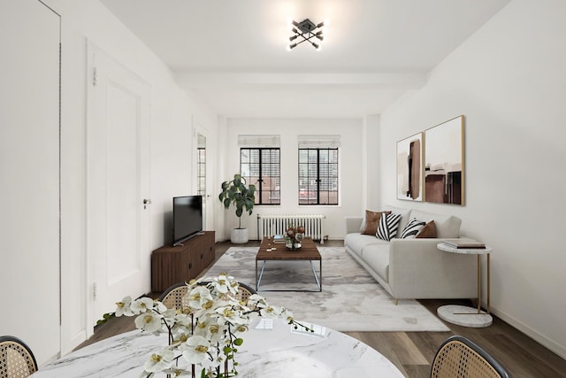 living area with radiator heating unit, baseboards, wood finished floors, and beamed ceiling