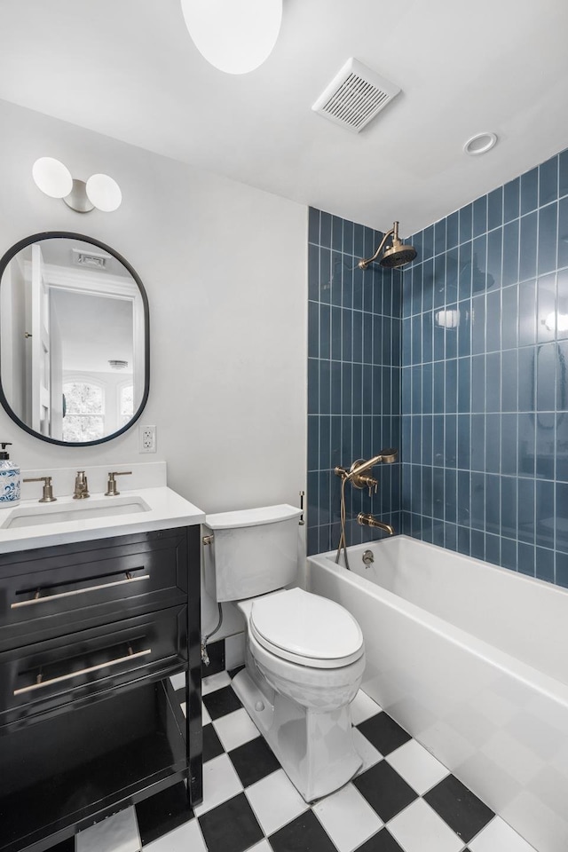 bathroom featuring visible vents, toilet, vanity, tile patterned floors, and shower / bathtub combination