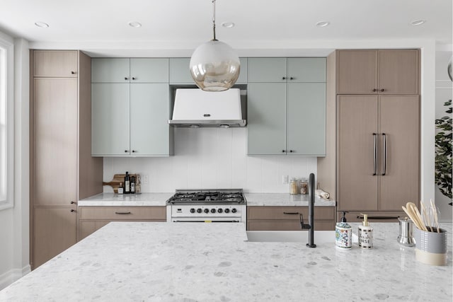 kitchen with light stone counters, pendant lighting, high end appliances, decorative backsplash, and exhaust hood