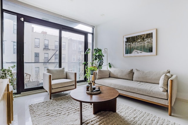 living area featuring a wall of windows and tile patterned flooring