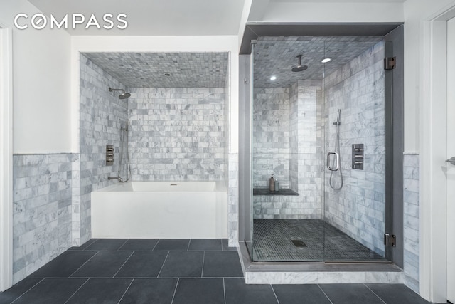 bathroom featuring wainscoting, tile walls, and tile patterned floors