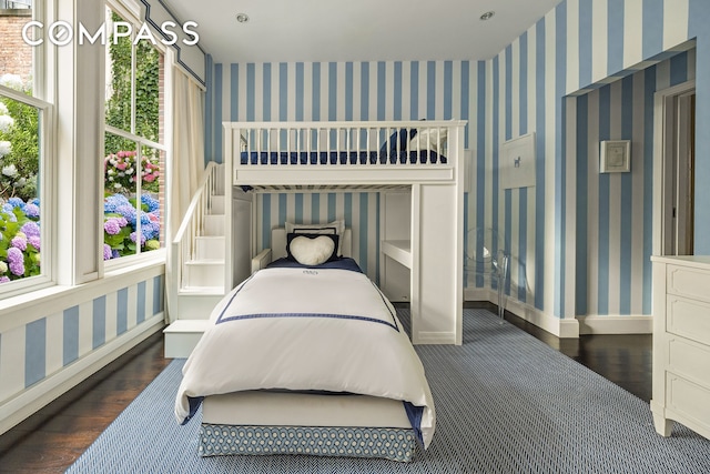 bedroom with wood finished floors and baseboards