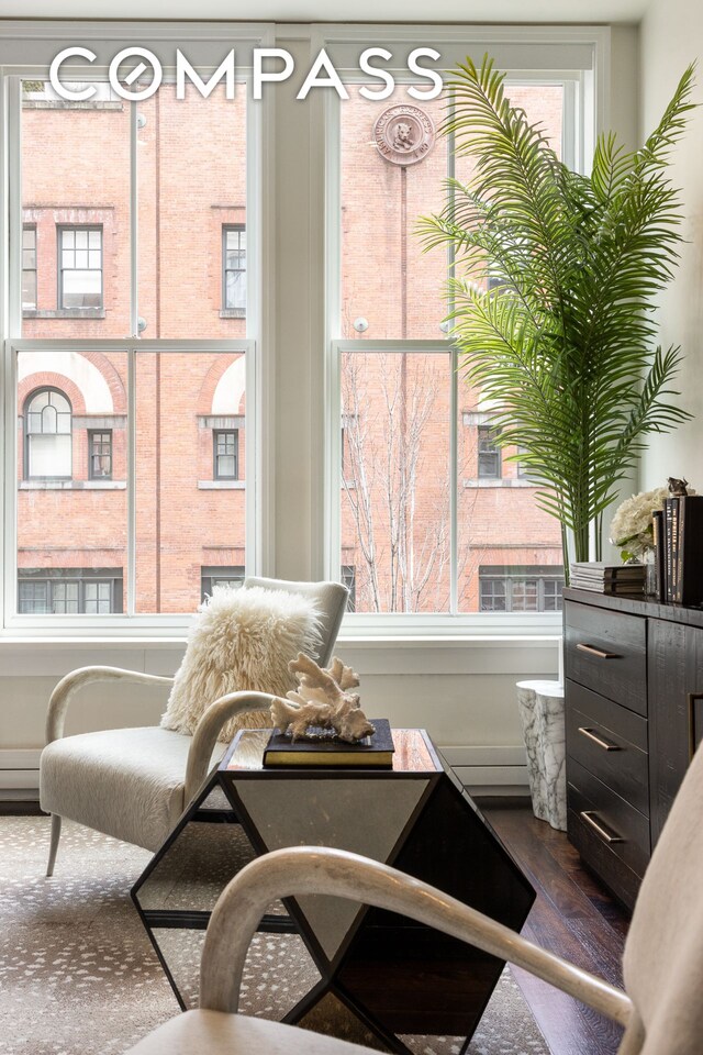 sitting room with dark wood-style flooring