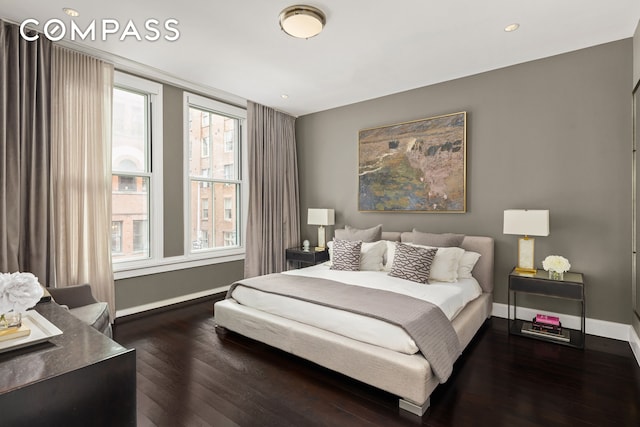 bedroom featuring wood finished floors, baseboards, and recessed lighting
