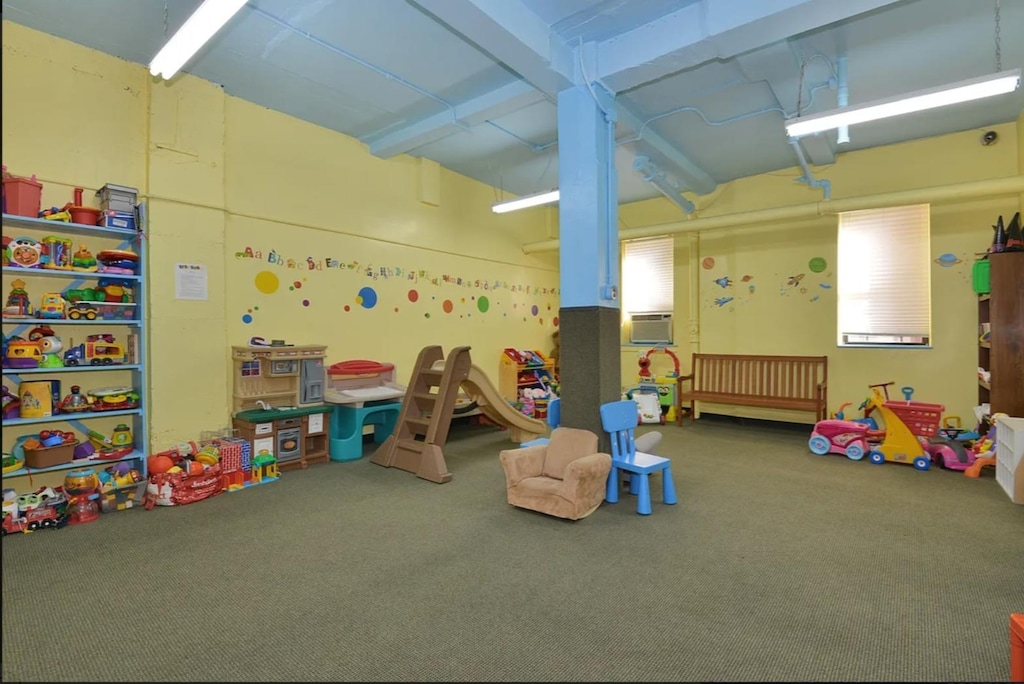playroom with a garage and carpet floors