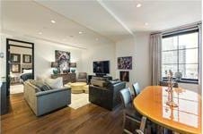 living room with dark wood-type flooring and recessed lighting