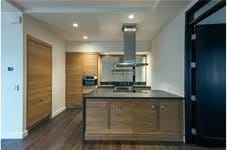 kitchen with dark countertops, baseboards, dark wood finished floors, and recessed lighting