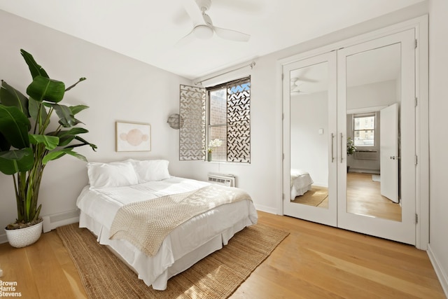 bedroom with light wood-style floors, ceiling fan, and baseboards