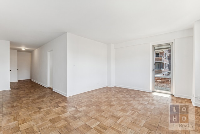 spare room featuring baseboards