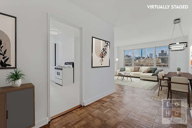 hallway featuring baseboards and a city view