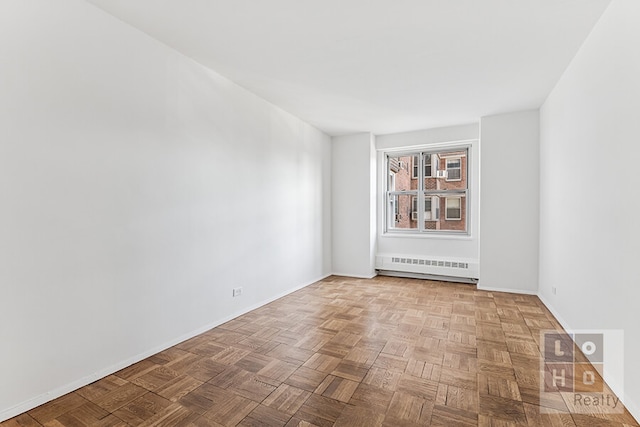 empty room with baseboard heating and baseboards