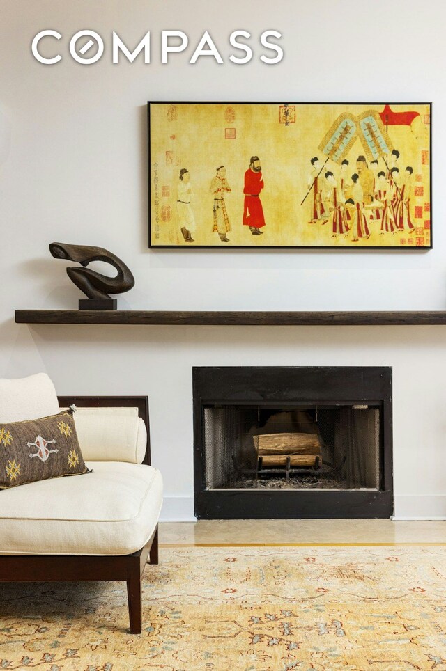 living room with visible vents, brick wall, a fireplace with flush hearth, wood finished floors, and recessed lighting