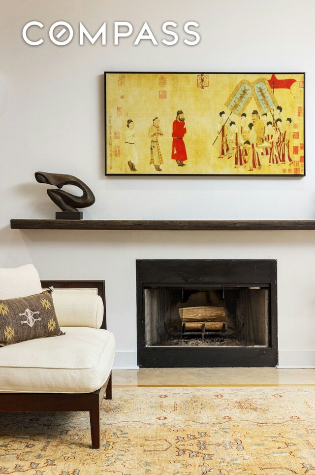 sitting room featuring baseboards and a fireplace