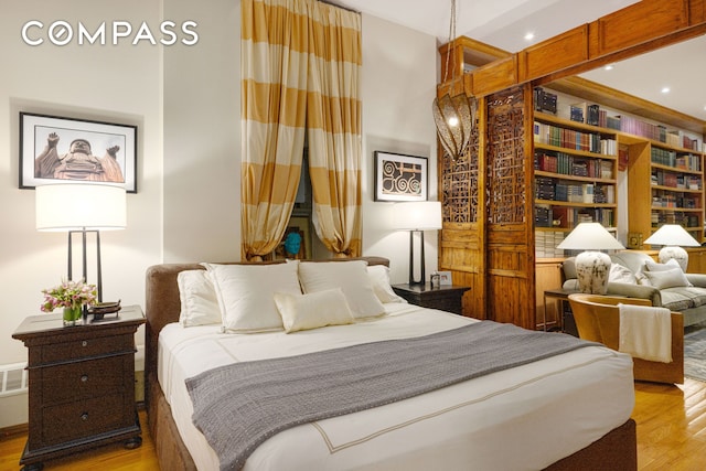 bedroom with recessed lighting, light wood finished floors, and visible vents