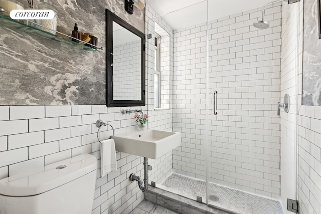 full bath featuring toilet, tile walls, and a shower stall