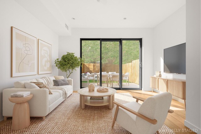 living room featuring light wood-style flooring and visible vents