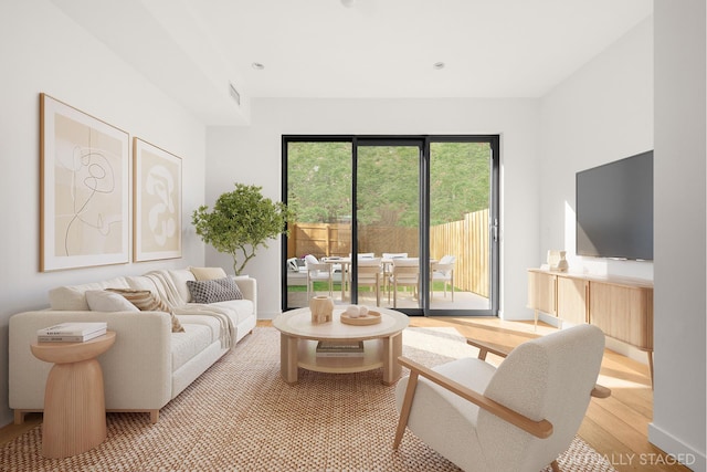 living area featuring baseboards, visible vents, and light wood-style floors
