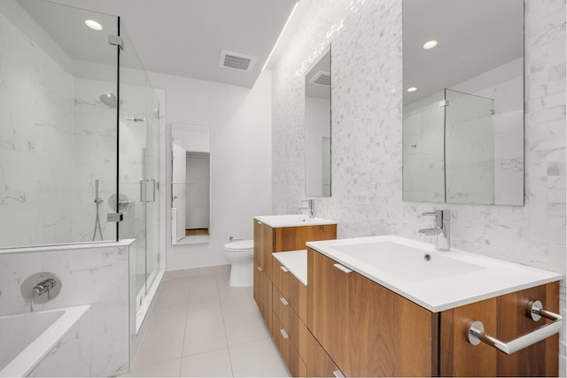 bathroom with a tub, visible vents, a sink, toilet, and a marble finish shower