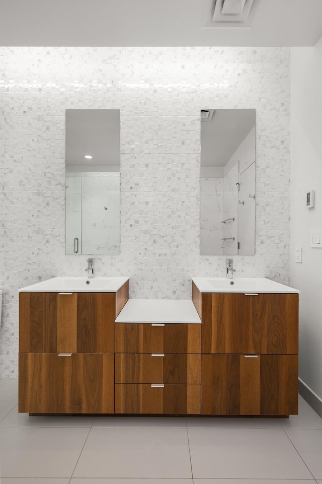 bathroom with two vanities, tile walls, and tile patterned floors