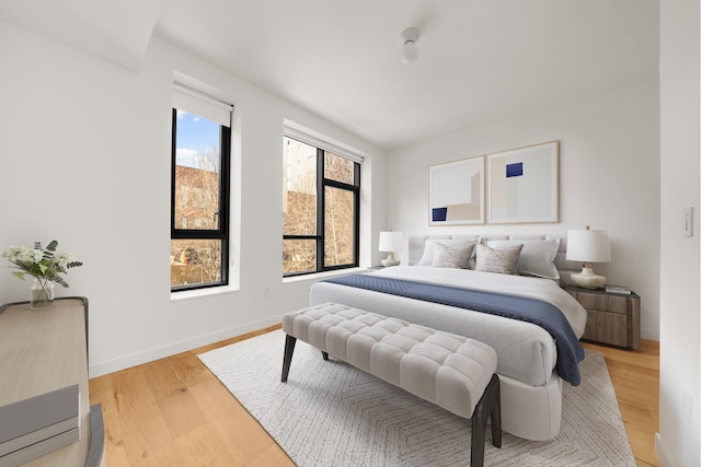 bedroom with baseboards and light wood-style floors