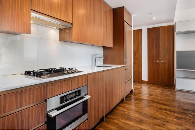 400 5th Ave Unit 43F, New York City, NY 10018 - kitchen with stainless steel appliances, modern cabinets, dark wood-style flooring, and light countertops