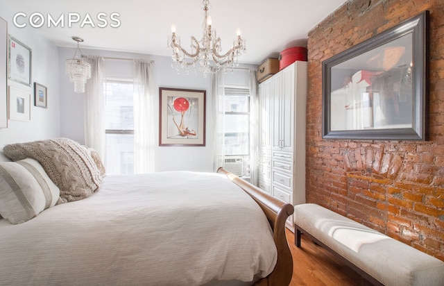bedroom with a chandelier and wood finished floors