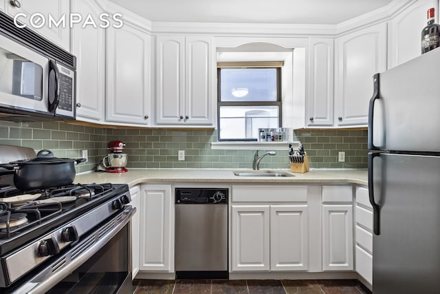 4 W 109th St Unit 6A, New York City, NY 10025 - kitchen with stainless steel appliances, white cabinetry, decorative backsplash, and light countertops
