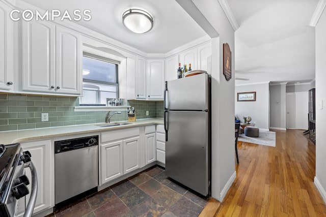 4 W 109th St Unit 6A, New York City, NY 10025 - kitchen with appliances with stainless steel finishes, white cabinetry, crown molding, and tasteful backsplash