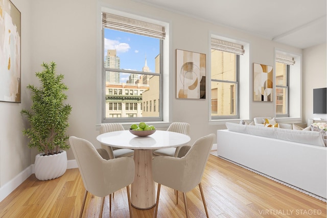 dining area featuring baseboards and wood finished floors