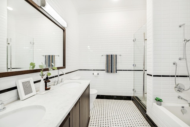 full bathroom featuring a tile shower, ornamental molding, a sink, and a tub