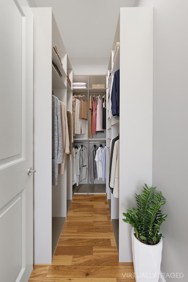 spacious closet with wood finished floors