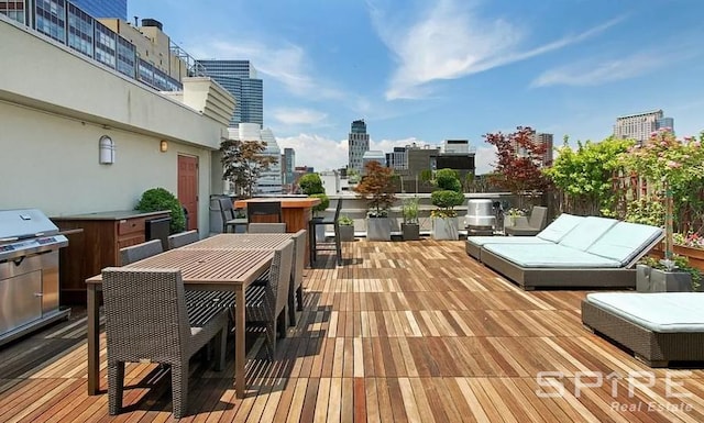 deck featuring a view of city and outdoor dining space