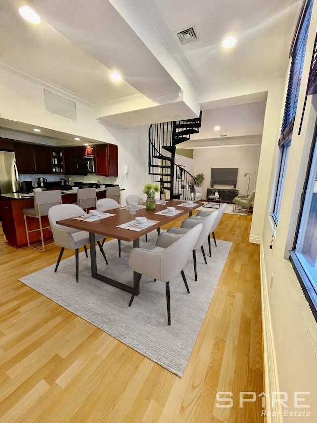 dining room with light wood-type flooring, visible vents, recessed lighting, and stairs