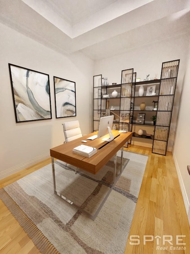 home office featuring baseboards and wood finished floors