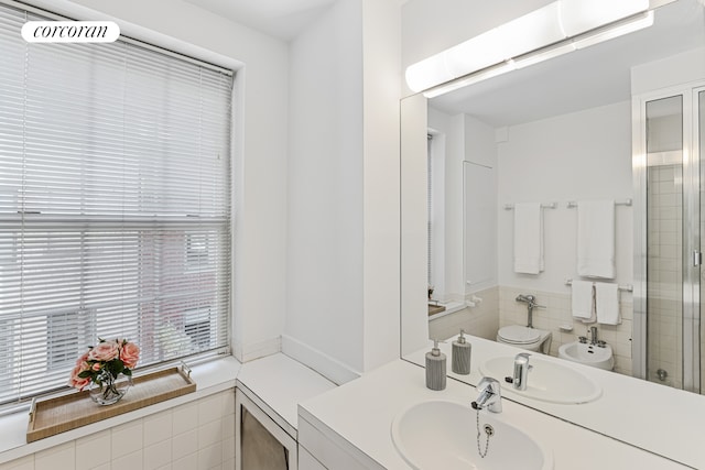 bathroom featuring a bidet, toilet, vanity, and a stall shower