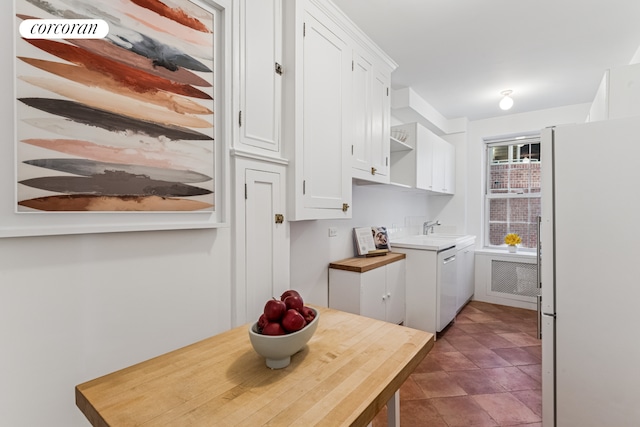 kitchen with white cabinets, open shelves, a sink, and white appliances