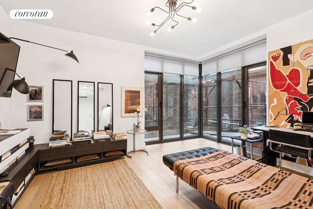 bedroom with access to outside, visible vents, a notable chandelier, and light wood-style flooring