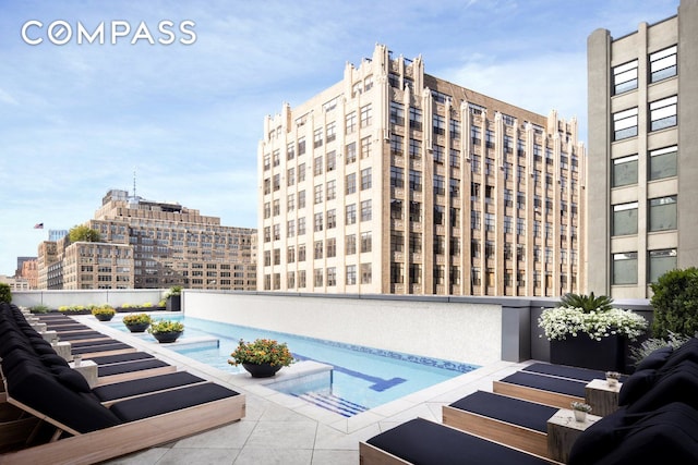 view of swimming pool with a city view